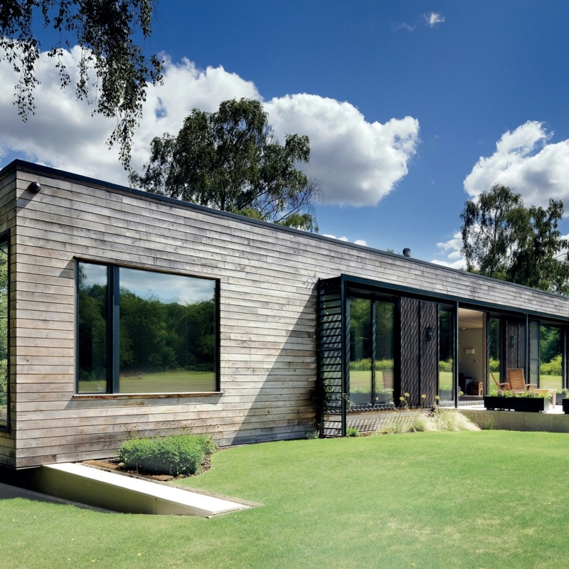 Minimalist Modular Home: Horizontal Wood Siding, Large Glass Doors