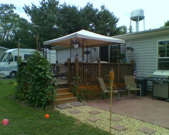Mobile Home Backyard with Gazebo Canopy & Lattice Skirting on Deck