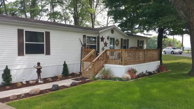 Mobile Home Deck: Raised Wooden Design & Rock-Lined Walkway