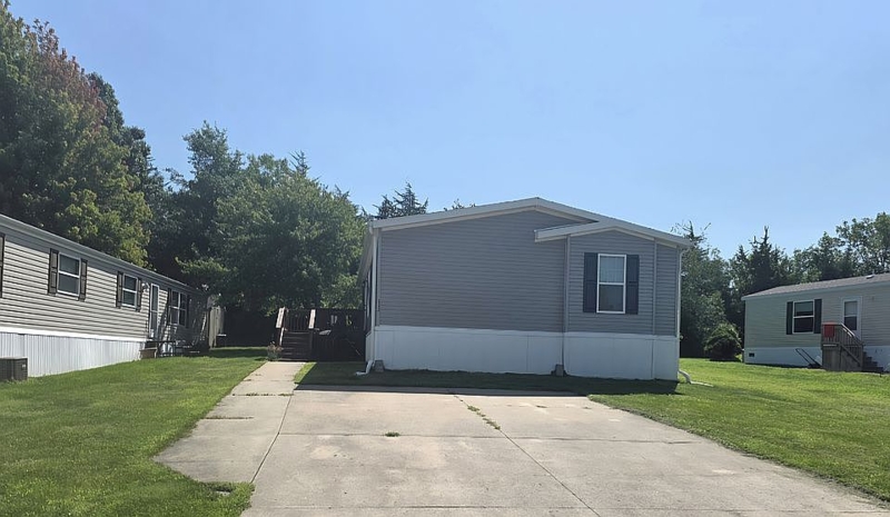 Mobile Home Double-Wide Gray Siding with Black Shutters and Concrete Pad