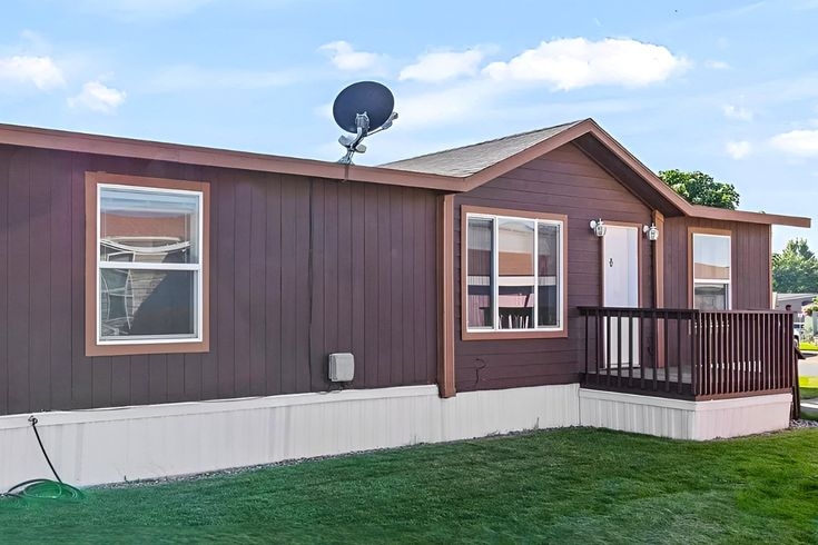 Mobile Home Espresso Siding with Wide White Trim and White Skirting