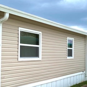 Mobile Home Exterior Beige Vinyl Siding with White Trim and Gutters