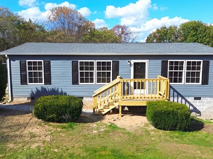 Mobile Home Exterior: Blue-Grey Siding with Black Louvered Shutters