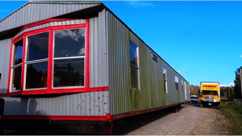 Mobile Home Exterior: Corrugated Metal Siding with Red Trim
