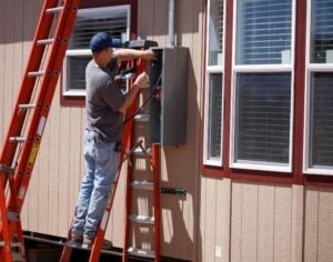 Mobile Home Exterior Electrical Repair featuring Orange Extension Ladder