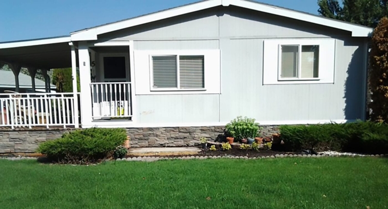 Mobile Home Exterior: Faux Stone Skirting with White Trim and Porch
