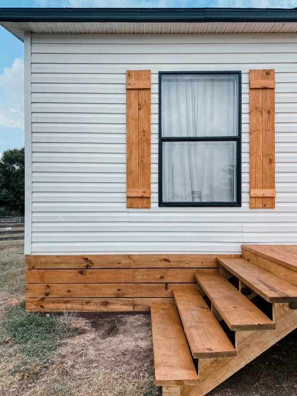Mobile Home Exterior: Honey Toned Wood Skirting with Matching Shutters