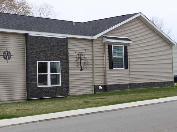 Mobile Home Exterior: Mixed Material with Stacked Stone Accents.