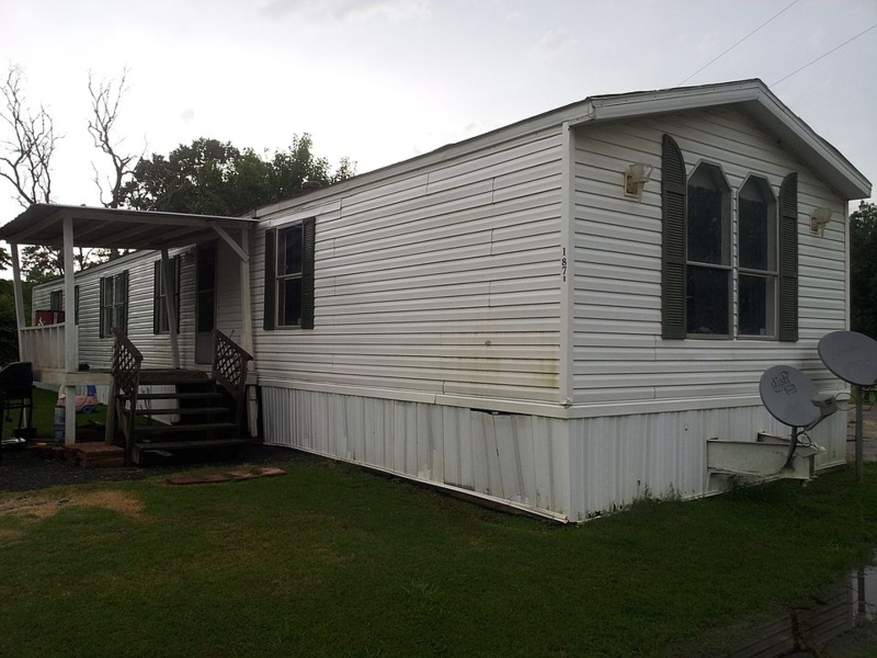 Mobile Home Exterior: Wooden Side Deck & Dark Contrast Shutters