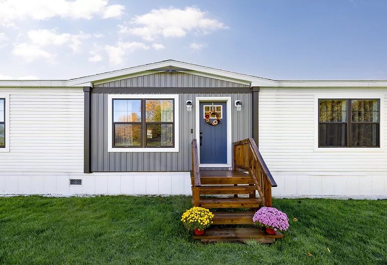 Mobile Home featuring Mixed Siding Textures and Slate Blue Door