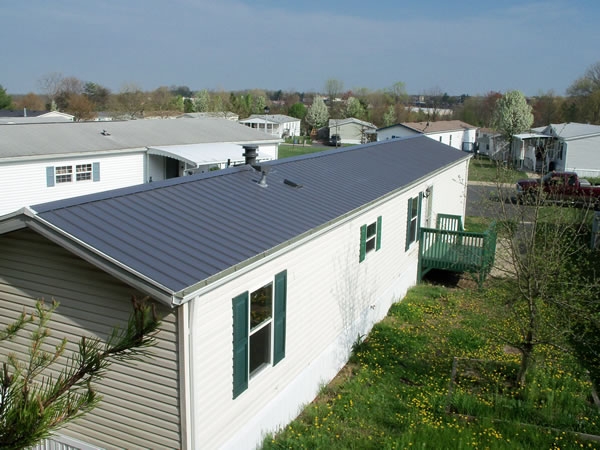 Mobile Home Metal Roof Over with Dark Green Trim Accents