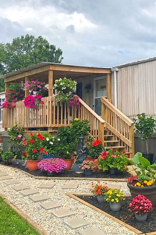 Mobile Home Porch Landscaping with Tiered Potted Garden and Gravel Path