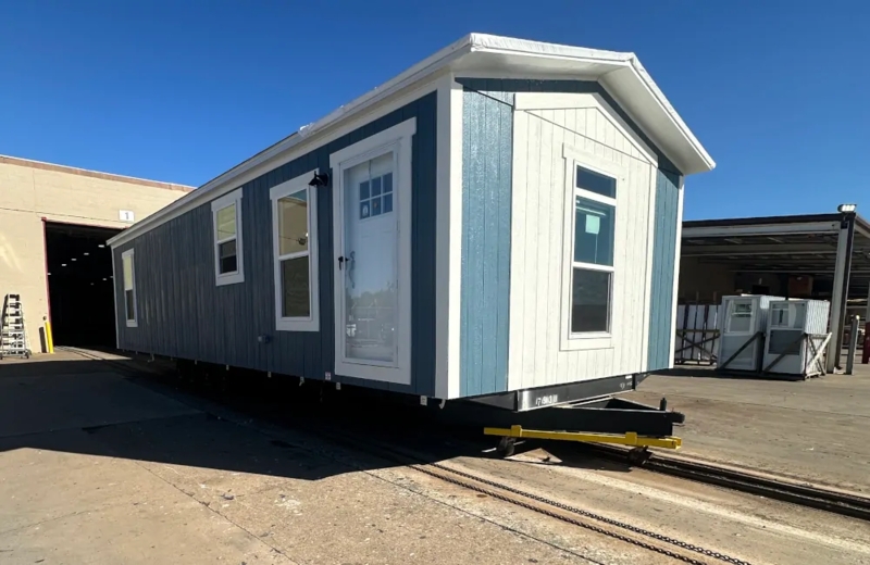 Mobile Home Single-Wide Vertical Siding with White Gabled Accent Design
