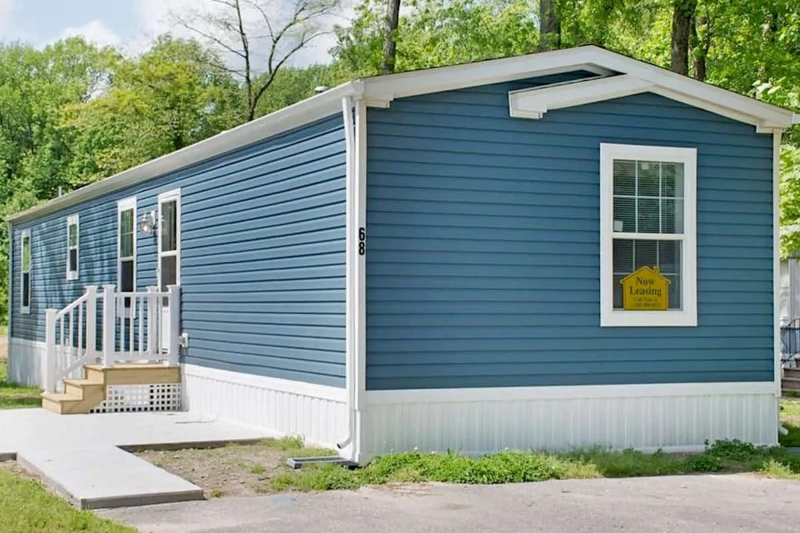 Mobile Home: Slate Blue Siding with White Lattice Skirting.