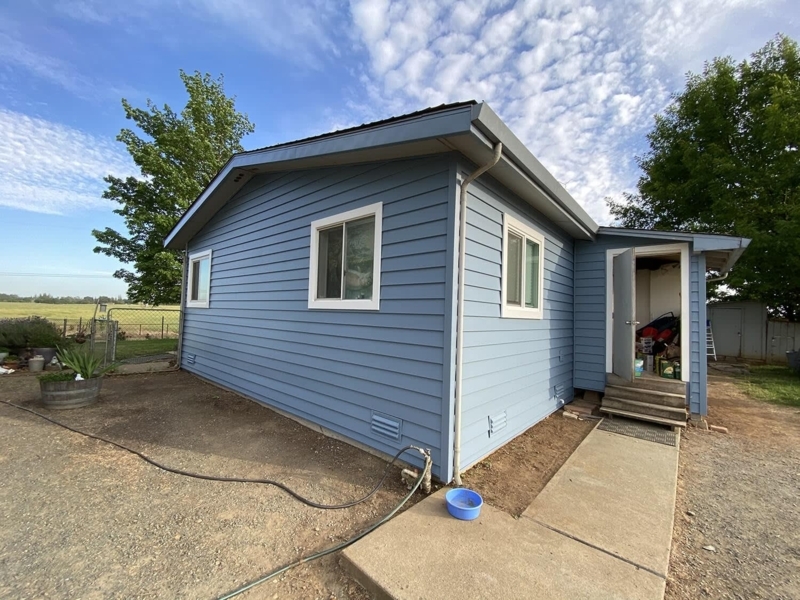Mobile Home: Traditional Blue Siding with White Trim.