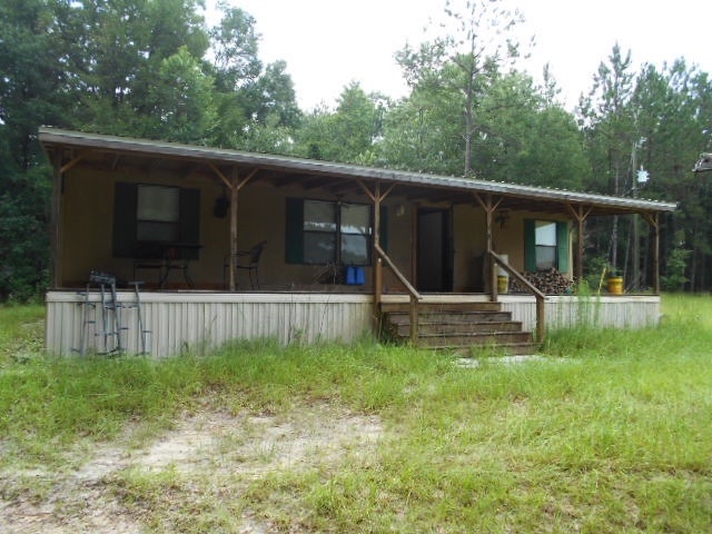 Mobile Home with Full-Length Covered Porch and Corrugated Metal Roof