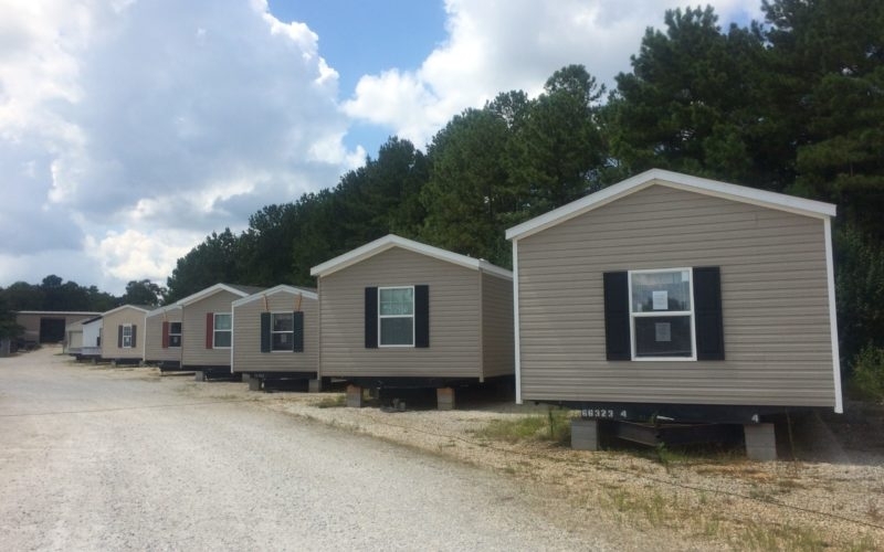 Mobile Home with Horizontal Siding and Dark Shutters Gable Roof