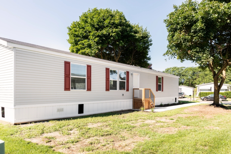 Mobile Home with Skirting Ventilation and Red Accent Shutters