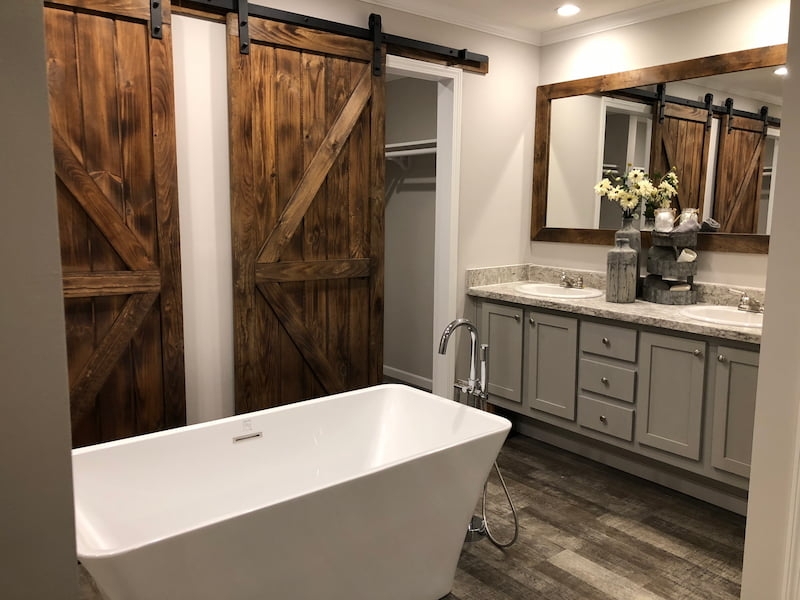 Modern Farmhouse Bathroom: Freestanding Tub with Rustic Barn Doors