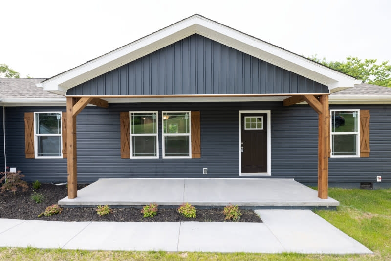 Modern Farmhouse Covered Porch Timber Pillars and Charcoal Siding