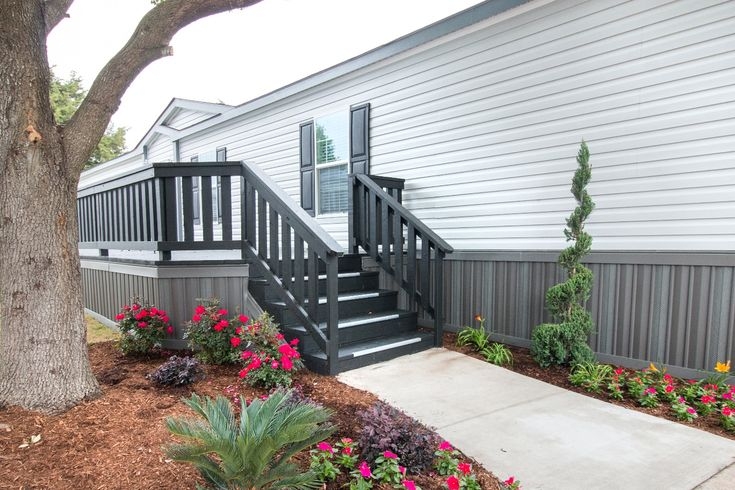 Modern Farmhouse Exterior Skirting: Gray Siding, Black Deck Contrast.
