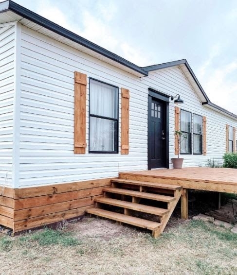 Modern Farmhouse Exterior: White Siding with Wood Toned Shutters & Deck