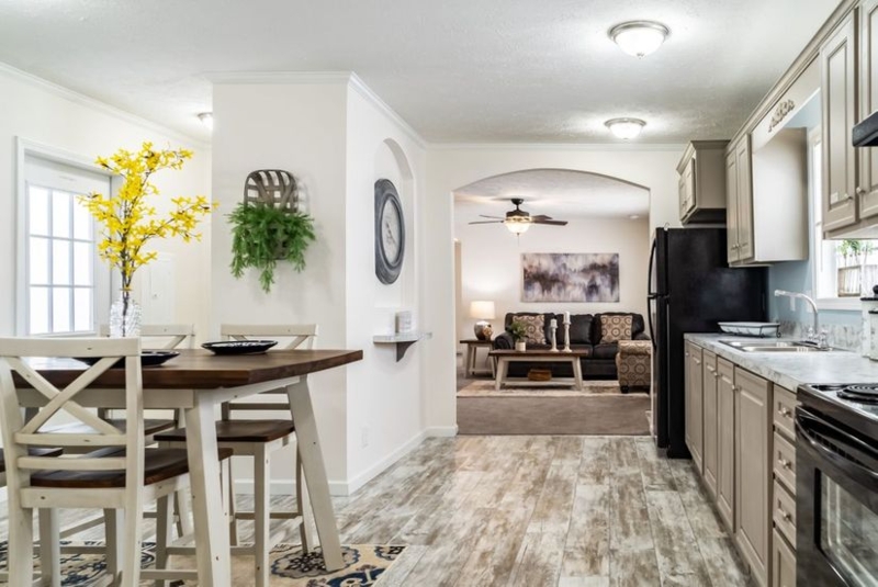 Modern Farmhouse Kitchen with Arched Entryway and Taupe Cabinetry