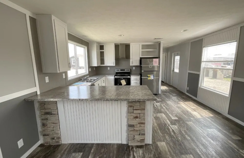 Modern Farmhouse Kitchen with Stone Accent Island and Gray Paneling