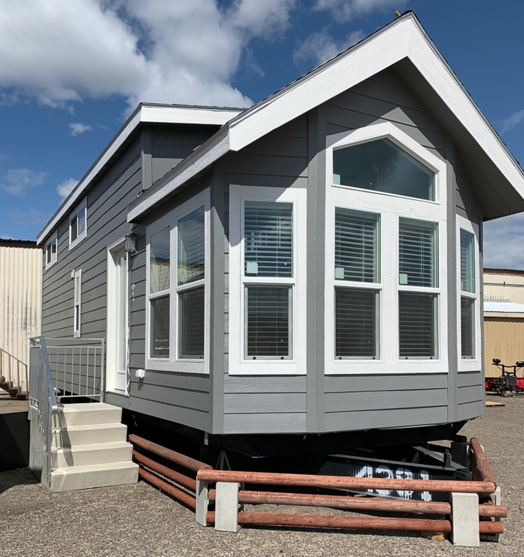 Modern Grey Manufactured Home with Large Arched Bay Window Front