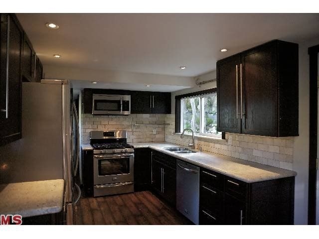 Modern Kitchen with Dark Shaker Cabinets and Stainless Steel