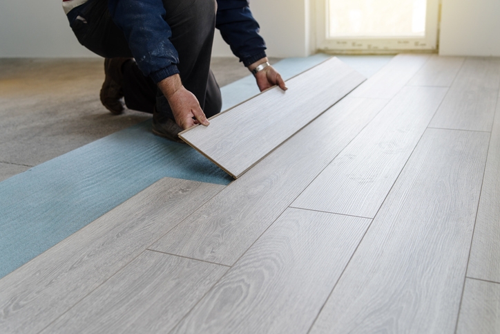 Modern Light Grey Vinyl Flooring Installation over Blue Foam Barrier