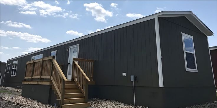 Modern Manufactured Home: Dark Grey Skirting, Wood Deck Contrast.