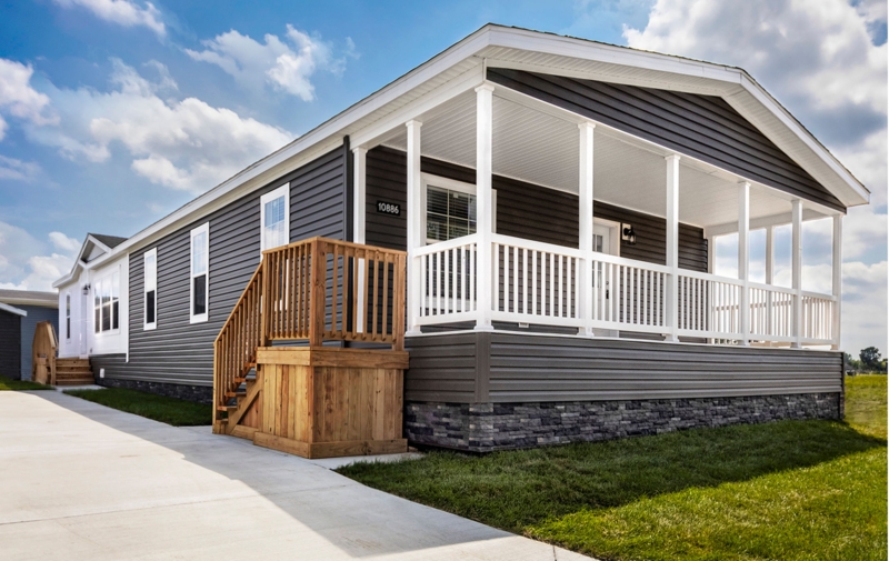 Modern Manufactured Home Exterior: Stone Skirting and Covered Porch