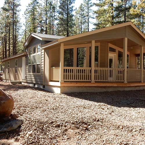 Modern Mobile Home Porch Addition: Shed Roofline in a Pine Forest Setting