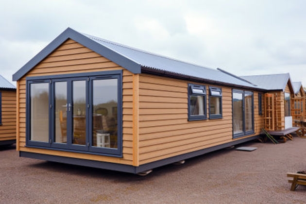 Modern Mobile Home with Expansive Sliding Glass Doors and Metal Roof