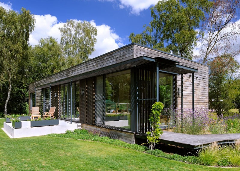 Modern Modular Home Exterior: Weathered Wood Siding, Glass Walls