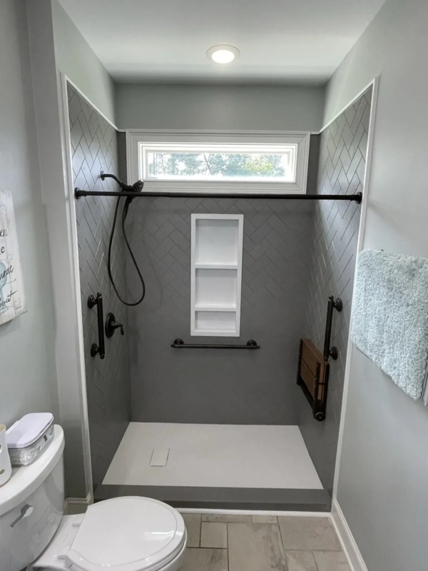 Modern Walk-In Shower: Gray Herringbone Tile and Fold-Down Seat