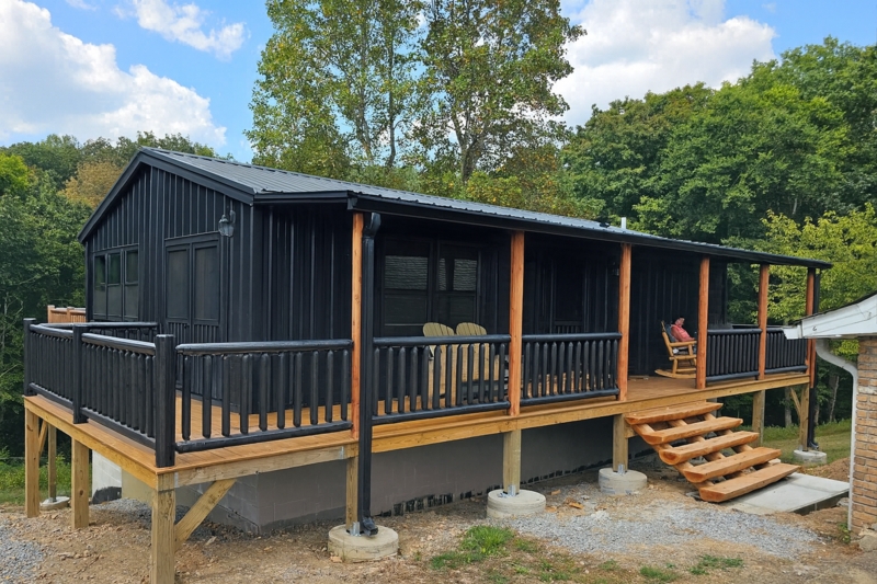 Modular Cabin Exterior with Chunky Log Railing and Slab Stairs Deck