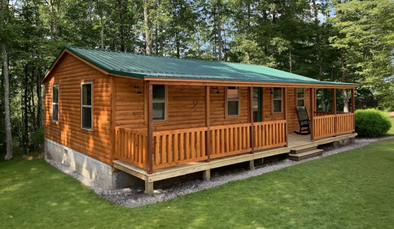 Modular Cabin with Full Porch Span and Green Metal Roof