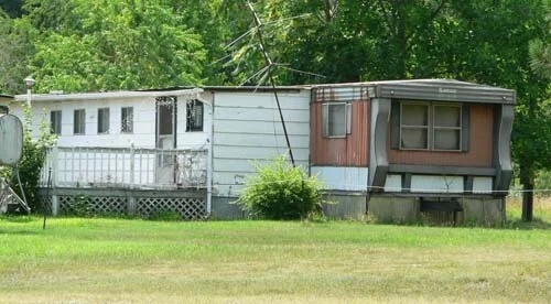 Modular Dwelling with Side Addition and Elevated Deck with Lattice Skirting