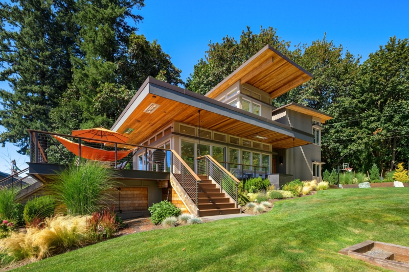 Modular Home with Cantilevered Roof and Floor-to-Ceiling Glass.
