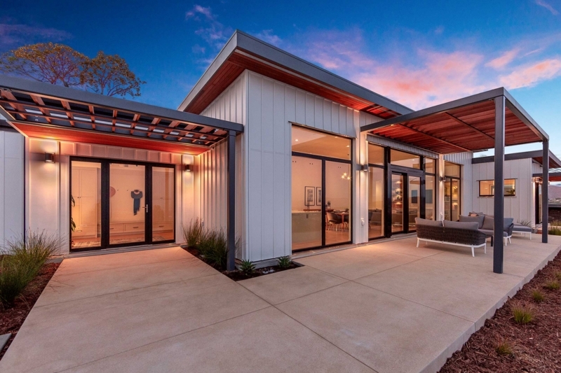 Modular Home with Net-Zero Design and a Slatted Pergola Patio.