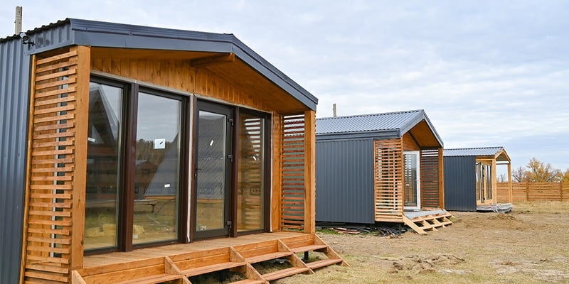 Modular Home with Ribbed Metal Siding and Slatted Wood Screens