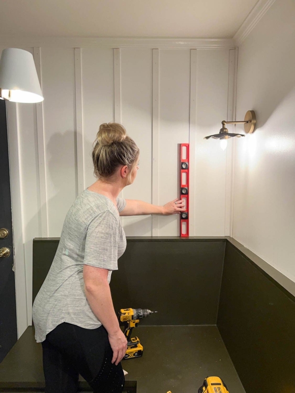 Mudroom with Deep Green Wainscoting and White Vertical Batten Pattern