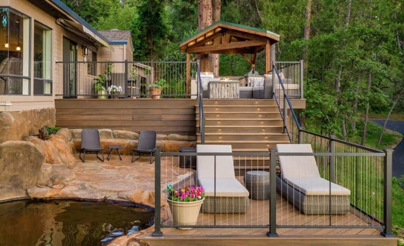 Multi-Level Backyard Deck with Integrated Pond and Sheltered Pavilion