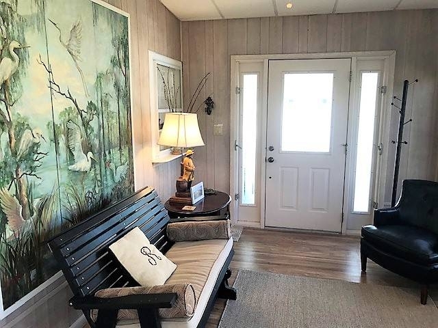 Nature-Inspired Foyer: Slatted Bench, Large Heron Mural, & Paneling