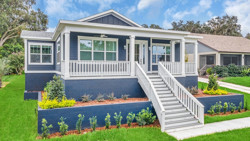 Navy House Exterior with Elevated Front Porch and Tiered Landscaping