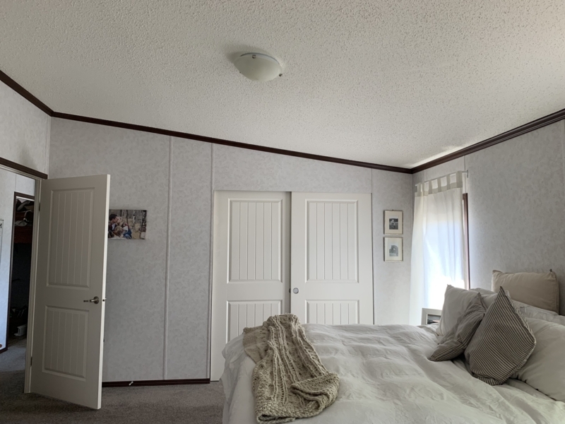 Neutral Bedroom with White Bedding and Contrasting Dark Crown Molding