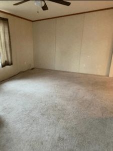 Neutral Empty Room with Beige Wall Batten Strips and Ceiling Fan