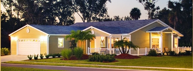 Olive Green Manufactured Home Exterior with White Picket Fence & Palms